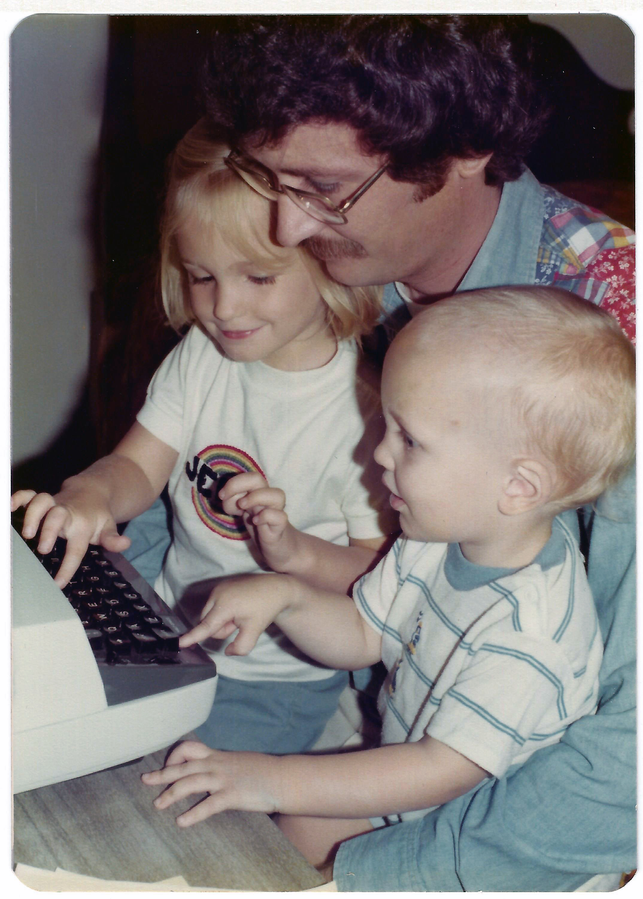 Jen Reeder with her brother Brian and her dad Tom Reeder typing on an IBM Selectric typewriter in 1976.